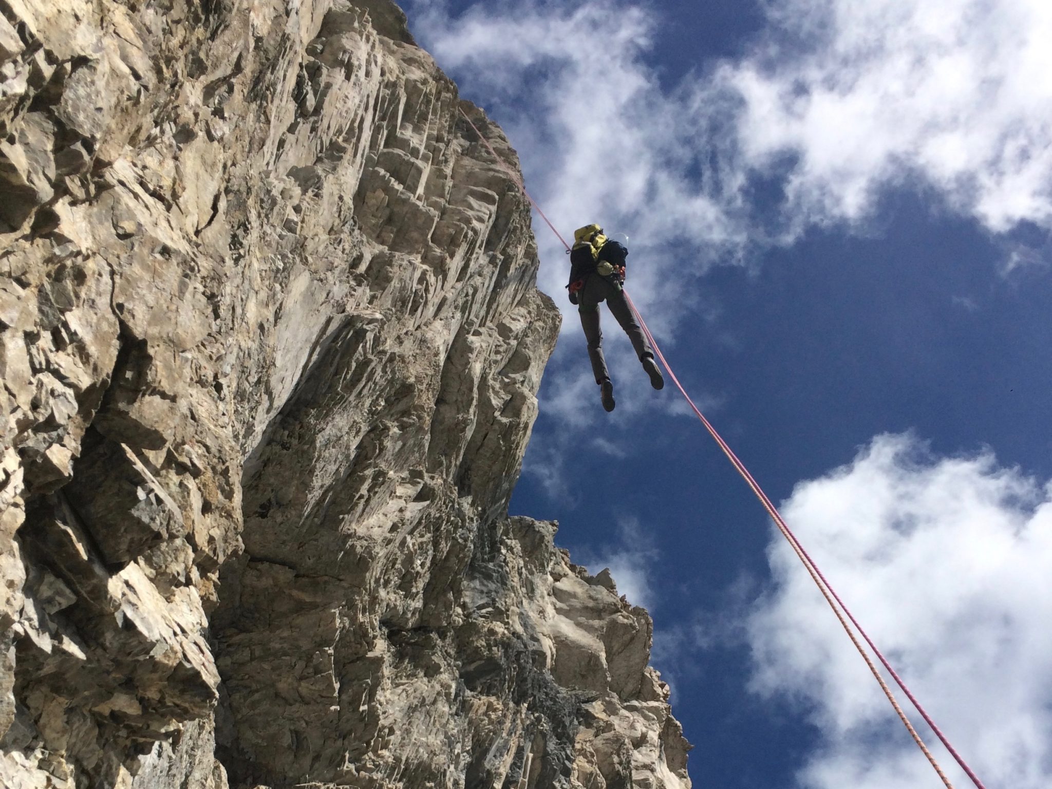 Rappeling down from a multipitch rock climb in Kananaskis