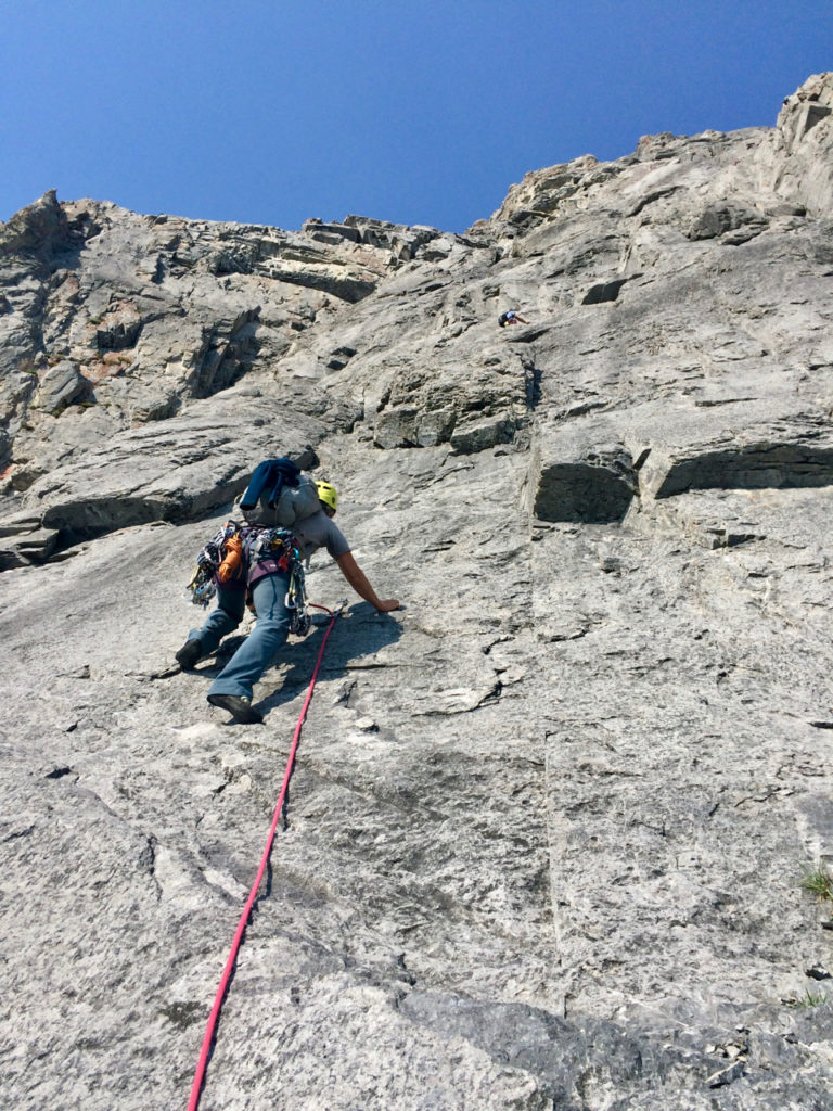 Leading up clean slabs on Ha Ling's NE Face route